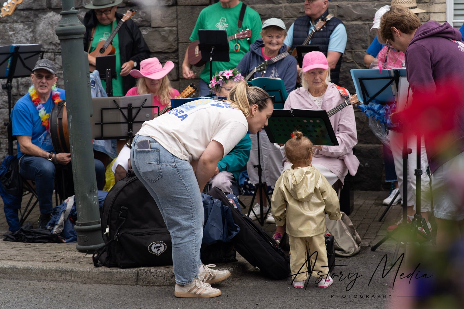 Parent and young girl enjoying Dundalk Ukulele Strummers at Greenore Heritage Week 2026